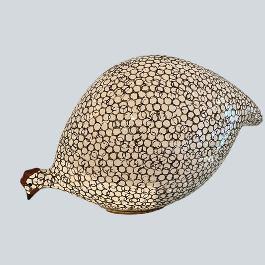 A handcrafted ceramic sculpture by LES CERAMIQUES DE LUSSAN, the Pecking Ceramic French Guinea Fowl in White Spotted Black, displays a striking black body adorned with white spots and stands on a pale cylindrical base against a minimalist white background—capturing the enduring elegance of South of France pottery.