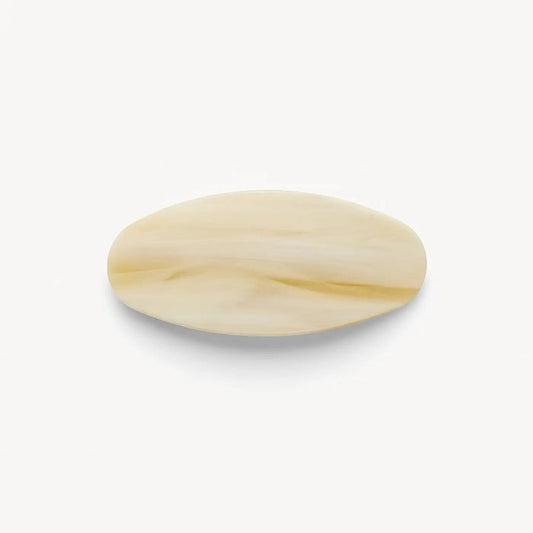 The MACHETE Jumbo Oval Barrette in Alabaster features a smooth, cream-colored, oversized oval design with subtle marbled patterns, shown on a plain white background.