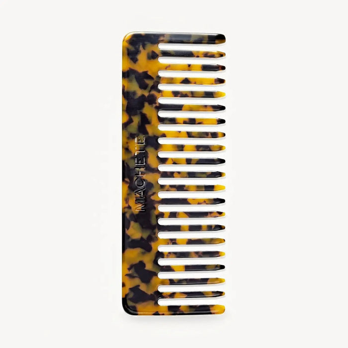 The MACHETE - NO2 Comb in Tortoise features wide teeth and a tortoiseshell pattern, handcrafted from Italian acetate with "MACHETE" engraved on the side, shown against a plain white background.