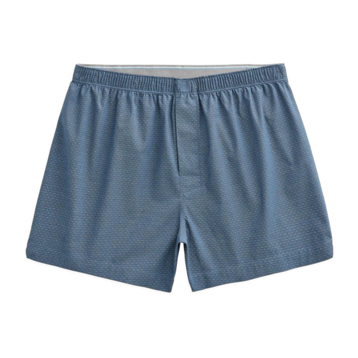 A person is shown from the waist down, wearing MACK WELDON 24/7 Woven Boxer in True Navy Dobby Dot. The background is plain and light gray.