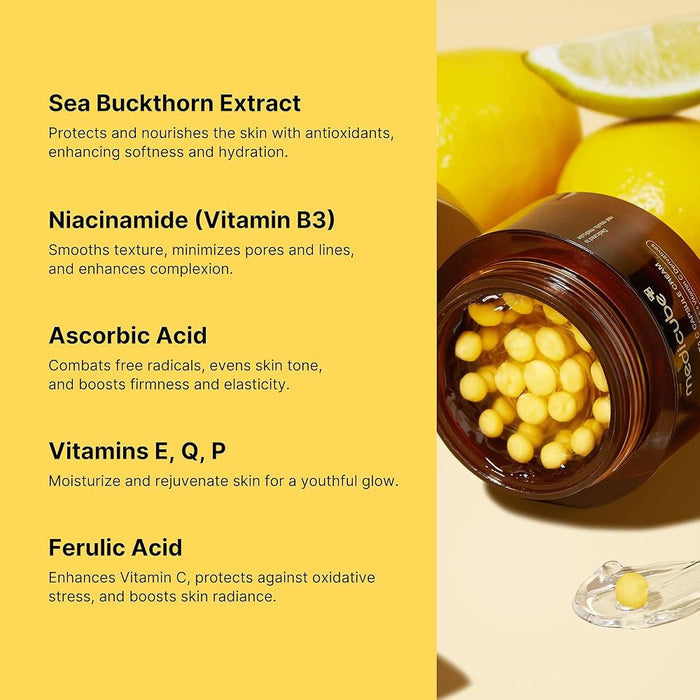 The GLOWISS MEDICUBE DEEP VITA C CAPSULE CREAM, shown in an open jar with yellow capsules on a yellow background and surrounded by lemons, features sea buckthorn, niacinamide, and ascorbic acid to brighten and even skin tone.