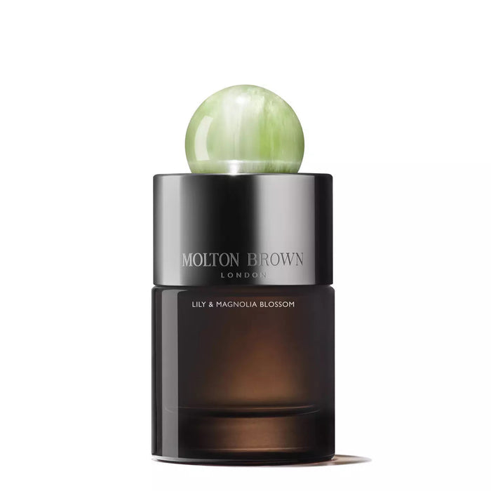 A dark glass bottle of MOLTON BROWN Lily and Magnolia Blossom Eau de Parfum, a sophisticated floral scent, topped with a round translucent green cap, displayed against a white background.