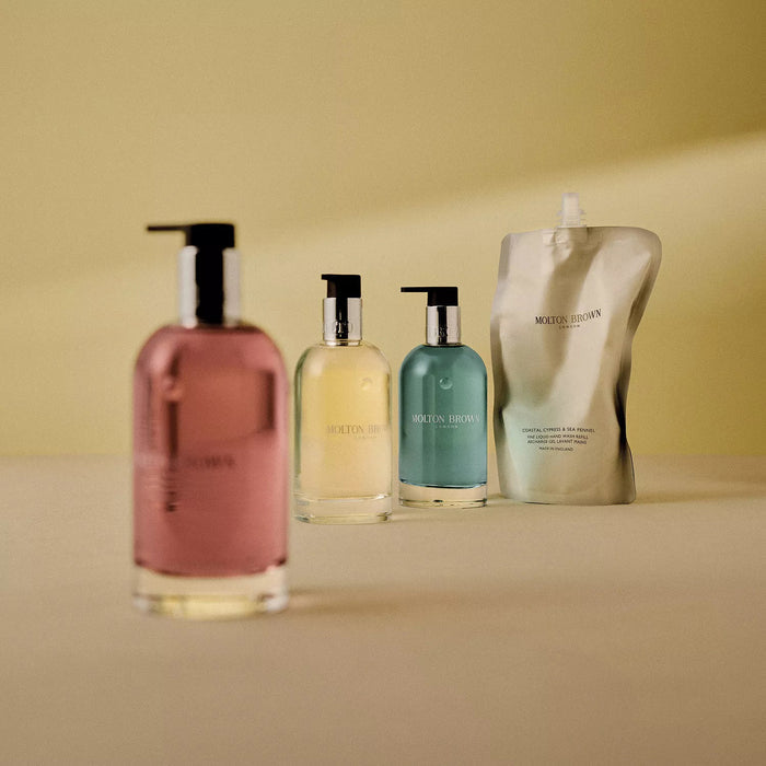 A clear glass bottle of MOLTON BROWN ORANGE & BERGAMOT HAND WASH with a silver pump and "MOLTON BROWN LONDON" on the front, displayed against a plain white background.