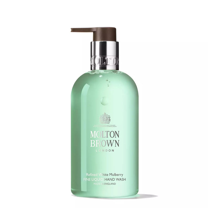 The MOLTON BROWN - WHITE MULBERRY AND THYME HAND WASH comes in a clear bottle with a silver and brown pump, light green liquid, and white and silver label for a luxurious hand washing experience.