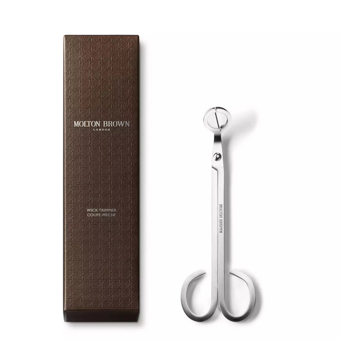 The MOLTON BROWN WICK TRIMMER features sleek stainless steel with a silver finish, circular blades, and curved handles—perfect for trimming scented candle wicks. The tool is shown vertically against a white background.
