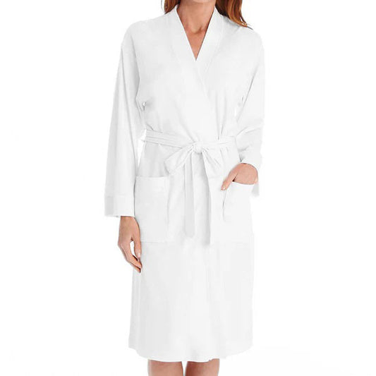 A person models the FASHIONVIEWS P. JAMAS - BUTTERKNIT SHORT ROBE, featuring long sleeves, front pockets, and a tied belt. Their head is partially out of frame against a plain background.