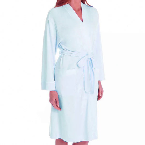 A person models the FASHIONVIEWS P. JAMAS - BUTTERKNIT SHORT ROBE, featuring long sleeves, front pockets, and a tied belt. Their head is partially out of frame against a plain background.