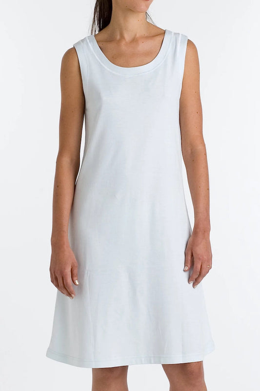 A woman models the FASHIONVIEWS P. JAMAS - BUTTERKNIT SLEEVELESS SHORT GOWN, a lightweight, knee-length white pima cotton dress, standing against a plain white background with arms relaxed at her sides and face partially out of frame.