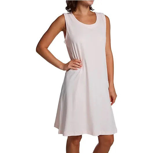 A woman models the FASHIONVIEWS P. JAMAS - BUTTERKNIT SLEEVELESS SHORT GOWN, a lightweight, knee-length white pima cotton dress, standing against a plain white background with arms relaxed at her sides and face partially out of frame.