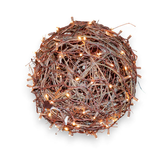 The PRE-LIT GRAPEVINE BALLS by EGRAPEVINESTORE is a 14-inch round, decorative nest made of intertwined twigs, adorned with tiny grapevine balls and mini Christmas lights for a warm glow against a plain white background.