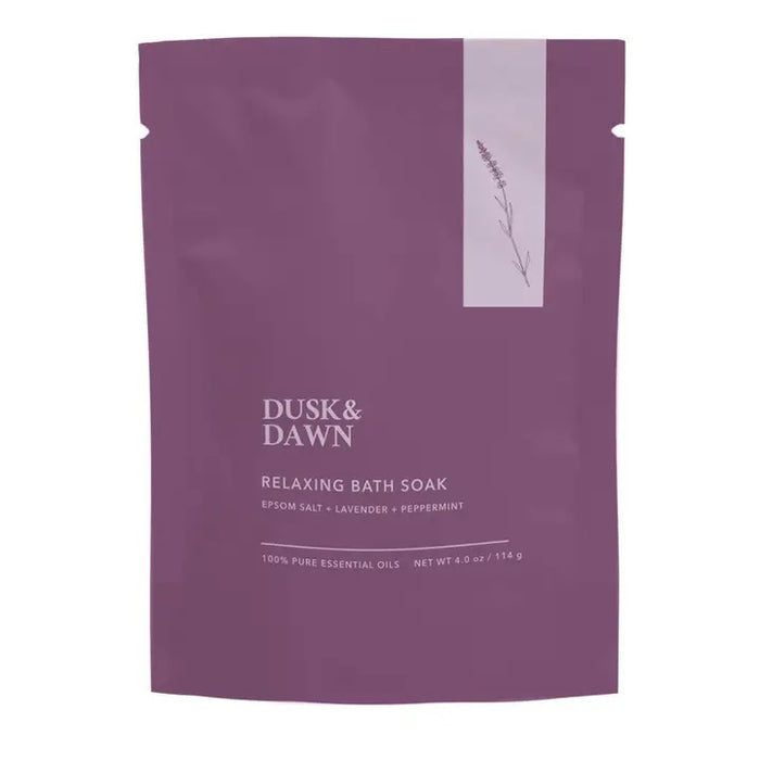 A purple pouch labeled "GIFTEN MARKET RELAXING BATH SOAK - LAVENDER AND PEPPERMINT" features white text, a lavender illustration, and contains Epsom salt. Resealable; net weight: 4 oz (114 g).