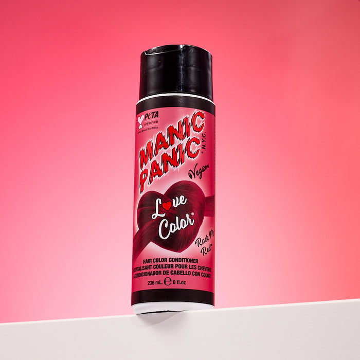 A bottle of Manic Panic® LOVE COLOR™ ROCK ME RED® conditioner. The packaging features red and blue graphics with text emphasizing the vegan formulation.