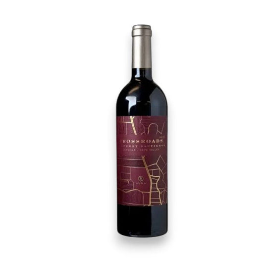A bottle of WINE: GRAPEVINE RUDD CROSSROADS CABERNET SAUVIGNON 2021 with a deep burgundy label, gold accents, and dark foil top—ideal for dinner parties. Displayed against a plain white background.