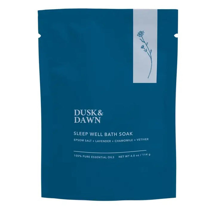 Blue packet labeled "SLEEP WELL BATH SOAK - EPSOM SALT AND LAVENDER" by GIFTEN MARKET, with Epsom salt, organic lavender, chamomile, and vetiver. Features a small floral illustration at the top right. Net wt: 4 oz (114g).