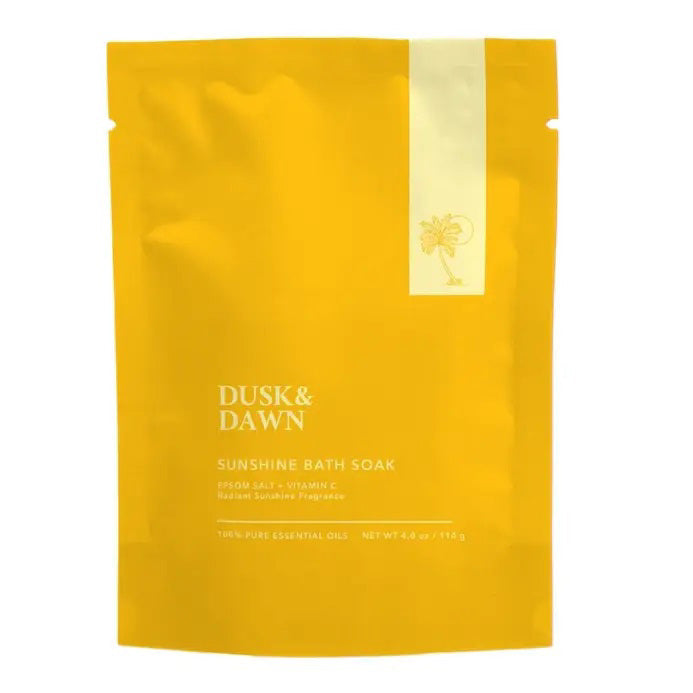 GIFTEN MARKET’s SUNSHINE BATH SOAK - EPSOM SALT AND VITAMIN C comes in a bright yellow pouch with minimalist design, a sun illustration, and clean text. Made with Epsom salt, vitamin C, organic lavender, and natural essential oils.