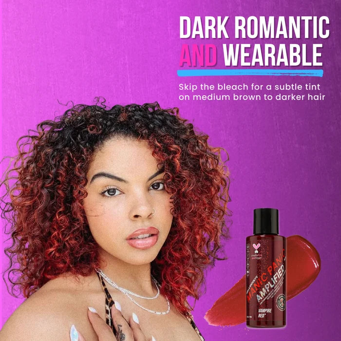 Woman withcurly vampire red amplified hair next to a hair dye  product bottle on a purple background
