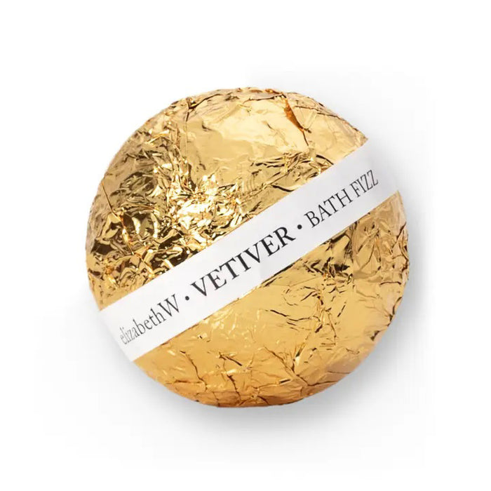 Indulge in a luxurious bath with the VETIVER FIZZ BALL from E WIGHTMAN & CO, elegantly wrapped in gold foil with a white label. Perfect for elevating your bath experience.